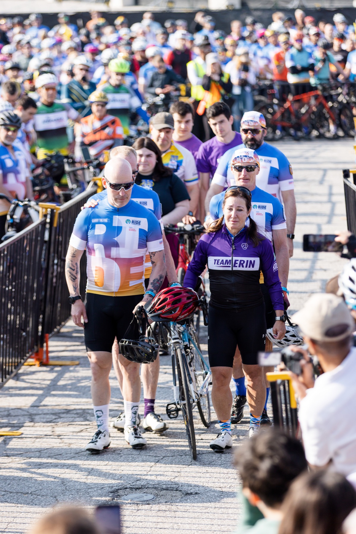 Team Erin members walking a bicycle together in remembrance at the 2025 Ride