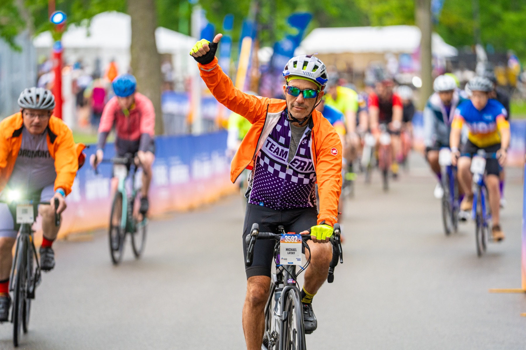 A Team Erin rider waves to the camera